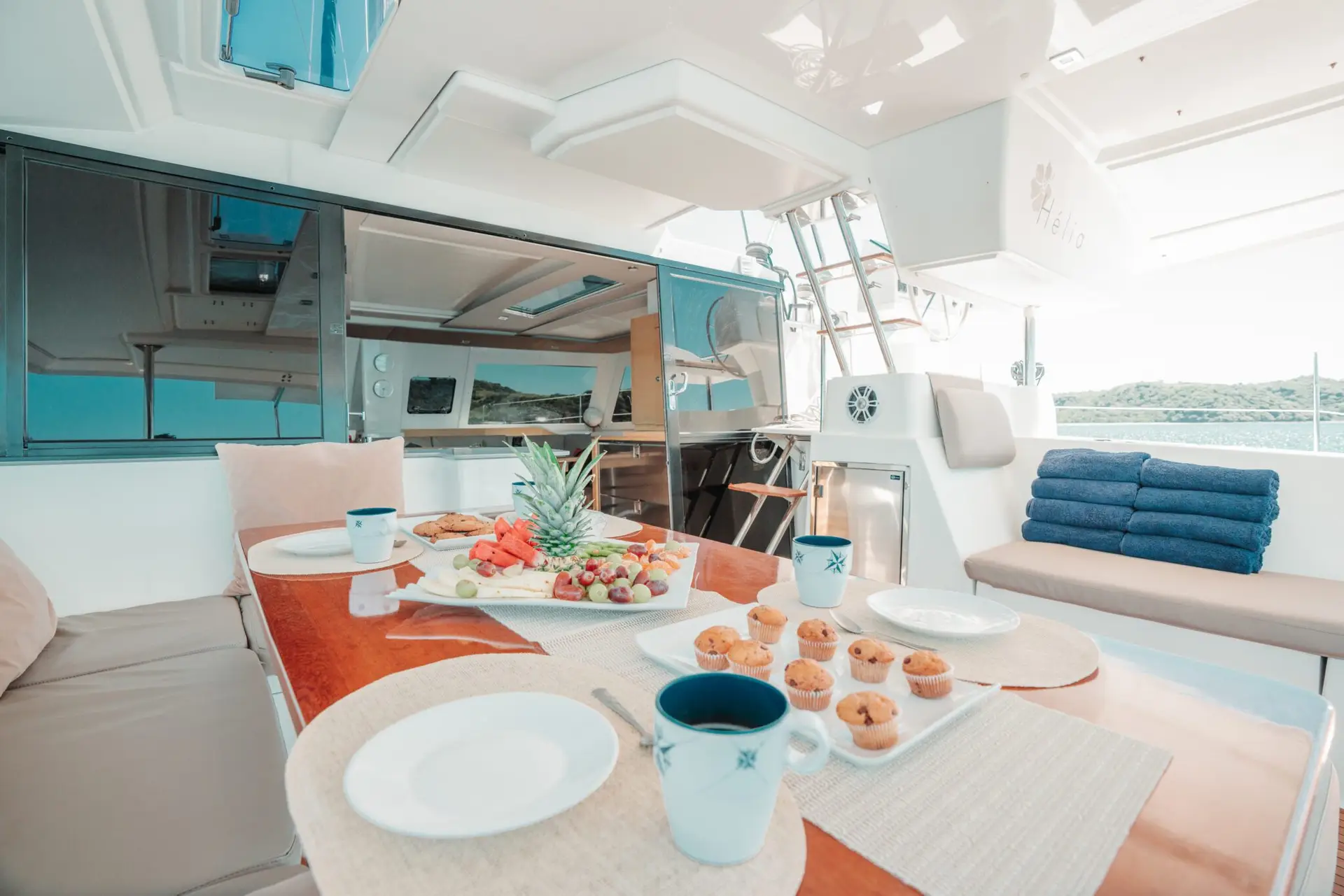 Dining table on a catamaran set with plates and cutlery
