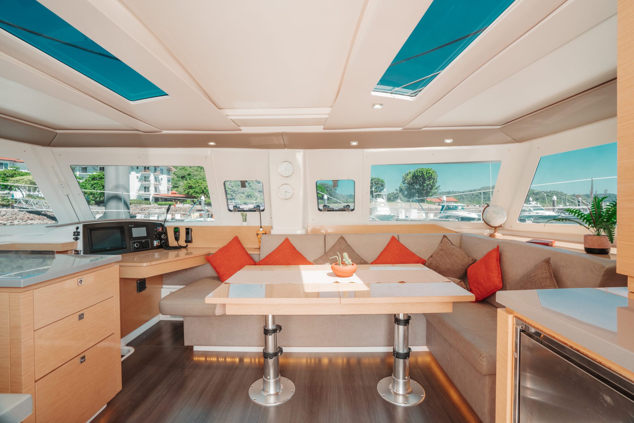 Interior of a catamaran featuring a dining table set with plates and cutlery