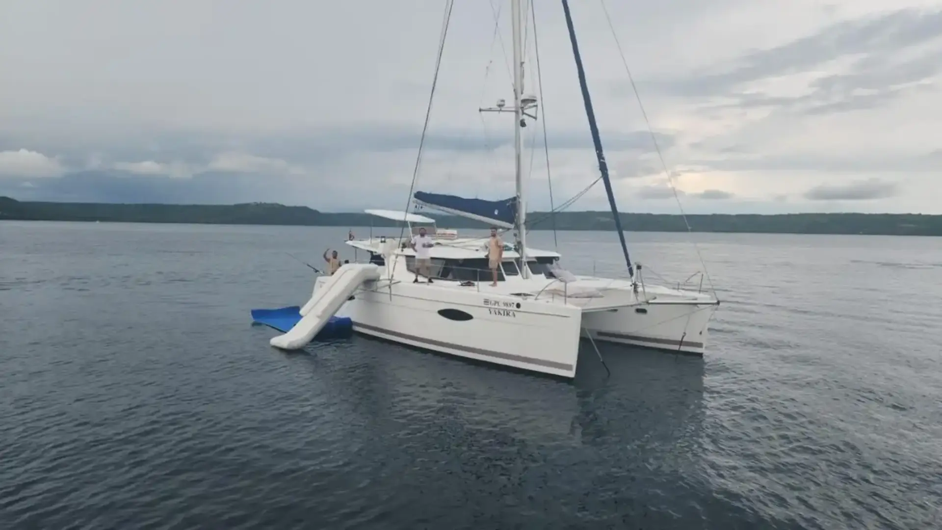 Catamaran exterior with a slide extending into the water.